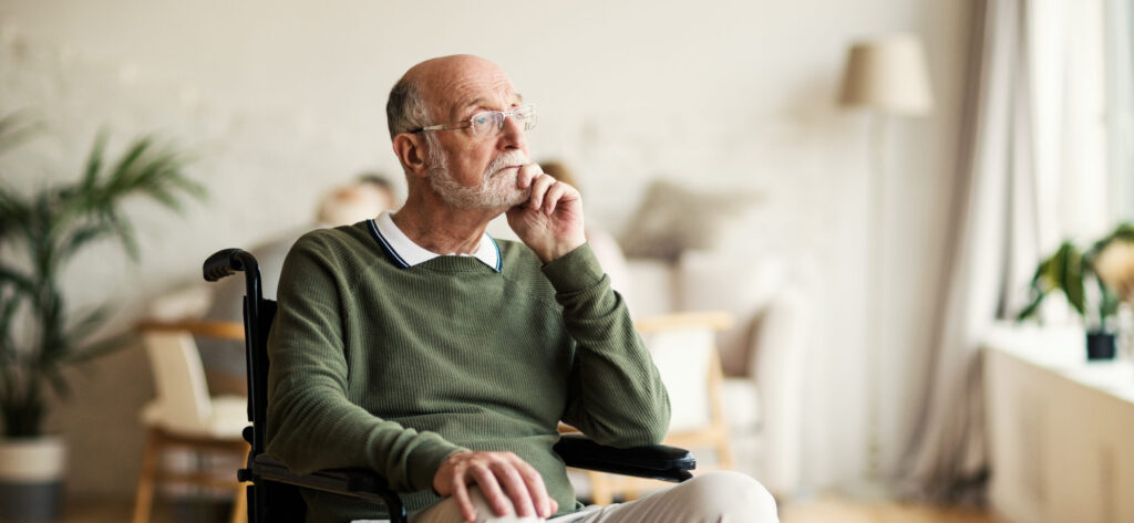 Disabled senior man thinking in nursing home